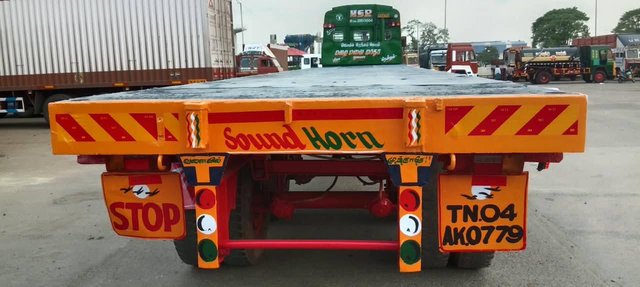 Empty 40 foot high-bed flatbed trailer photographed from behind