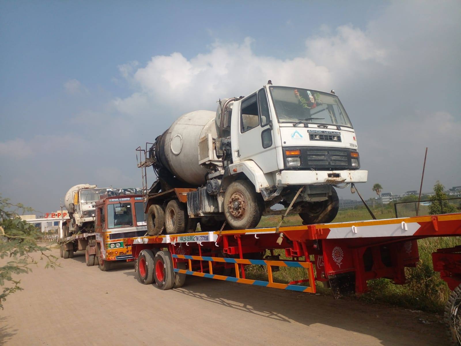 Concrete transit mixer truck carried as cargo on a low-bed trailer