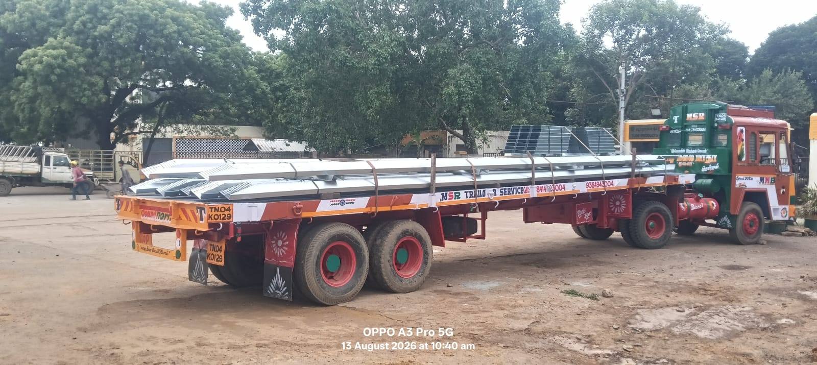 Solar modules and profiled steel sheet loaded on a long flatbed trailer