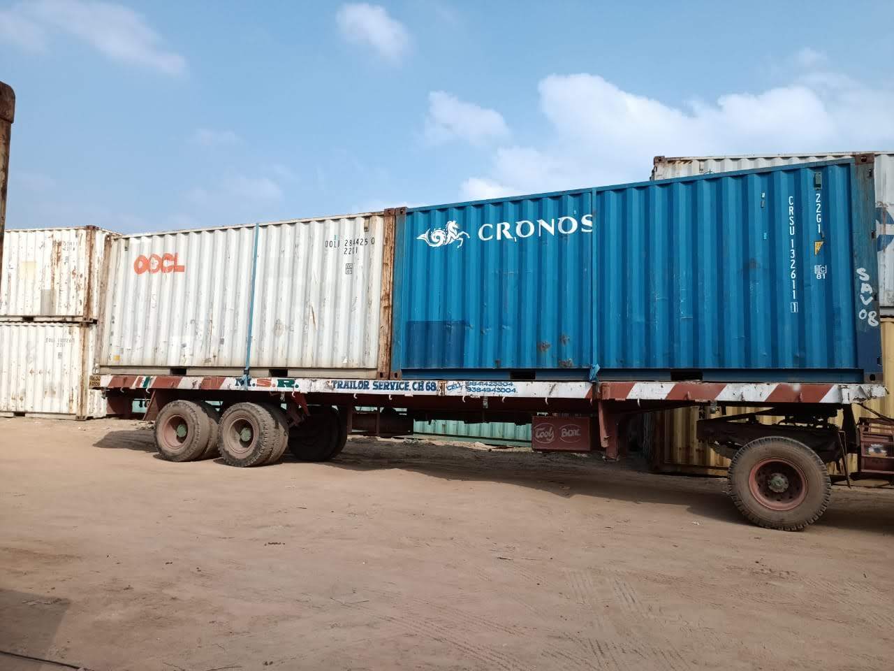 Two 40 ft shipping containers loaded end to end on an MMM trailer